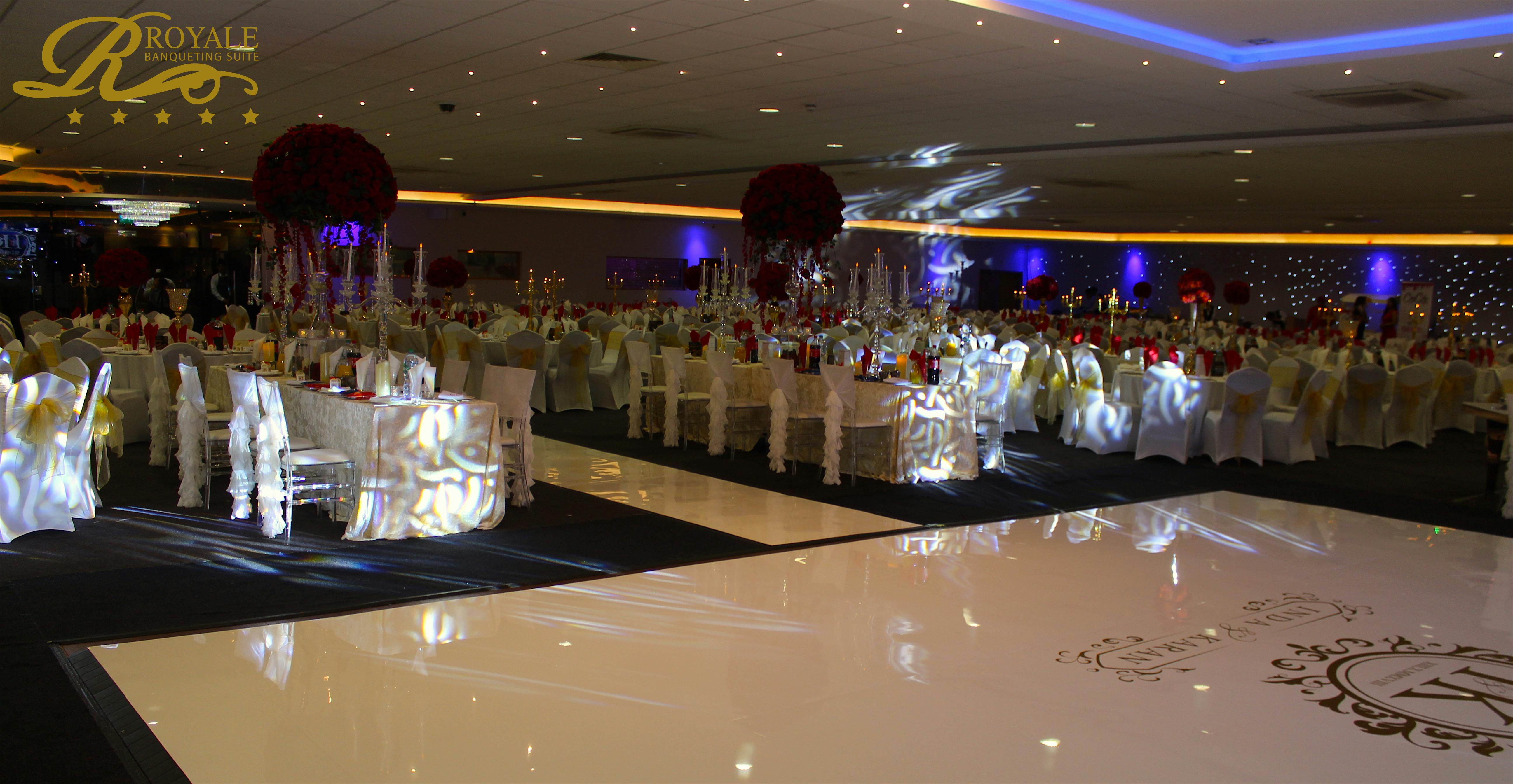 Elegant banquet hall with white linens, perfect for weddings and corporate events.