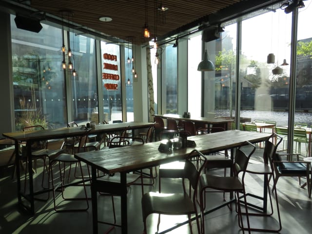 Modern event space at KuPP with large windows, ideal for corporate and social gatherings.
