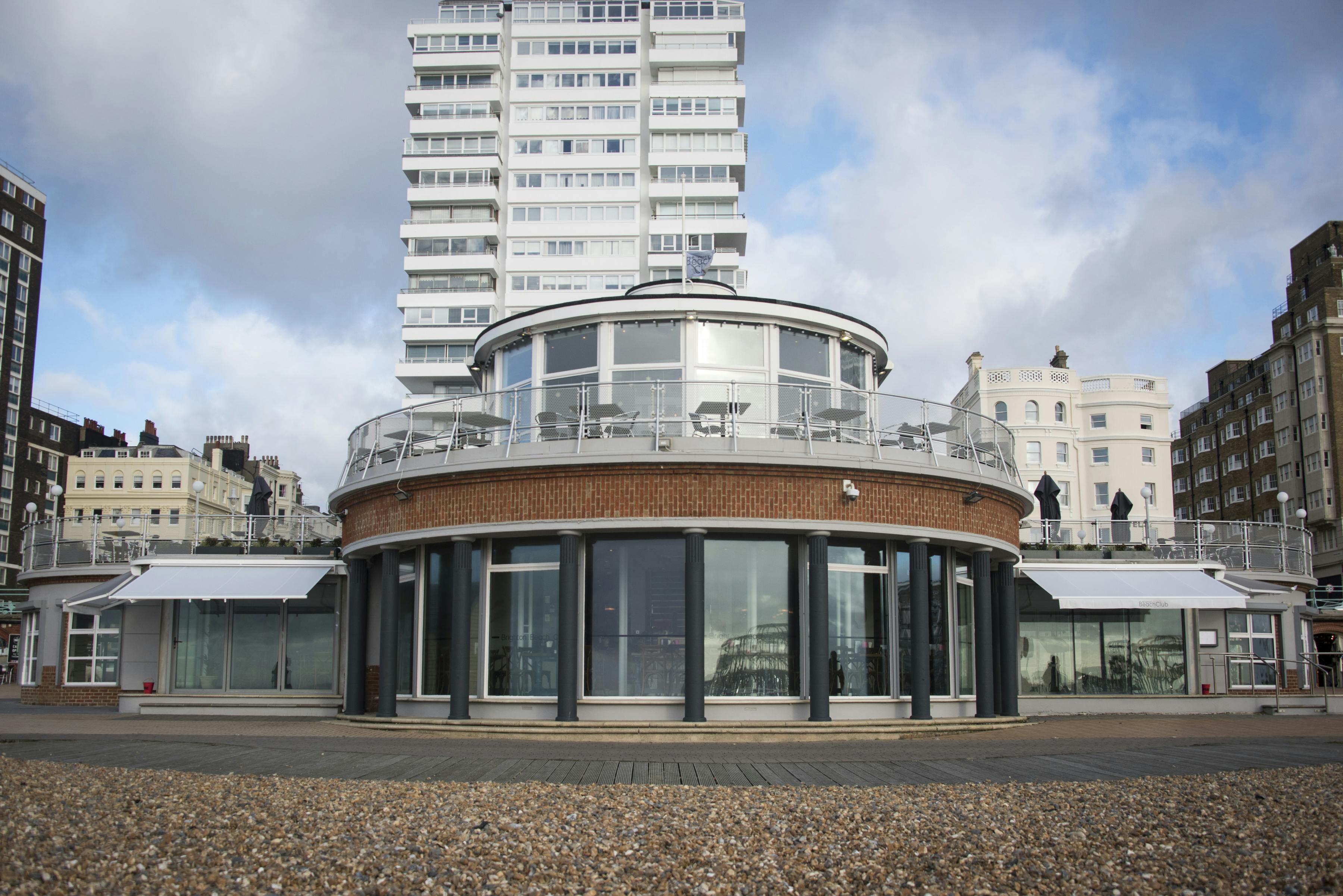 Modern circular venue with glass windows at Brighton Beach Club for events and gatherings.