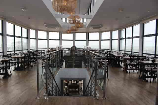 Modern event space with panoramic windows at Brighton Beach Club, ideal for gatherings.