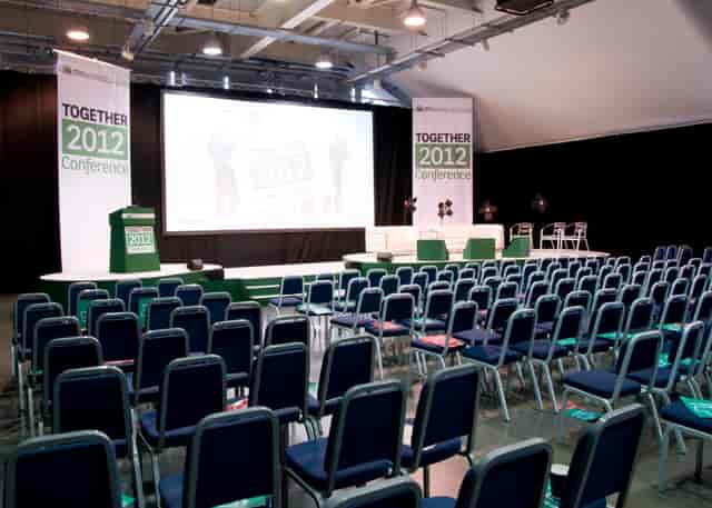 Newbury Racecourse Grandstand conference setup with stage and seating for events.