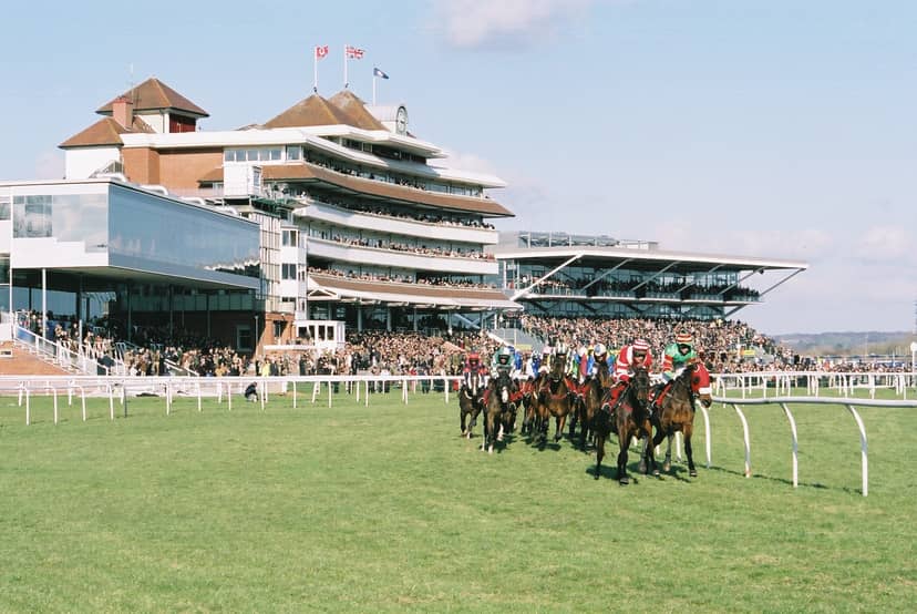 "Newbury Racecourse grandstand filled with spectators at a vibrant horse racing event."