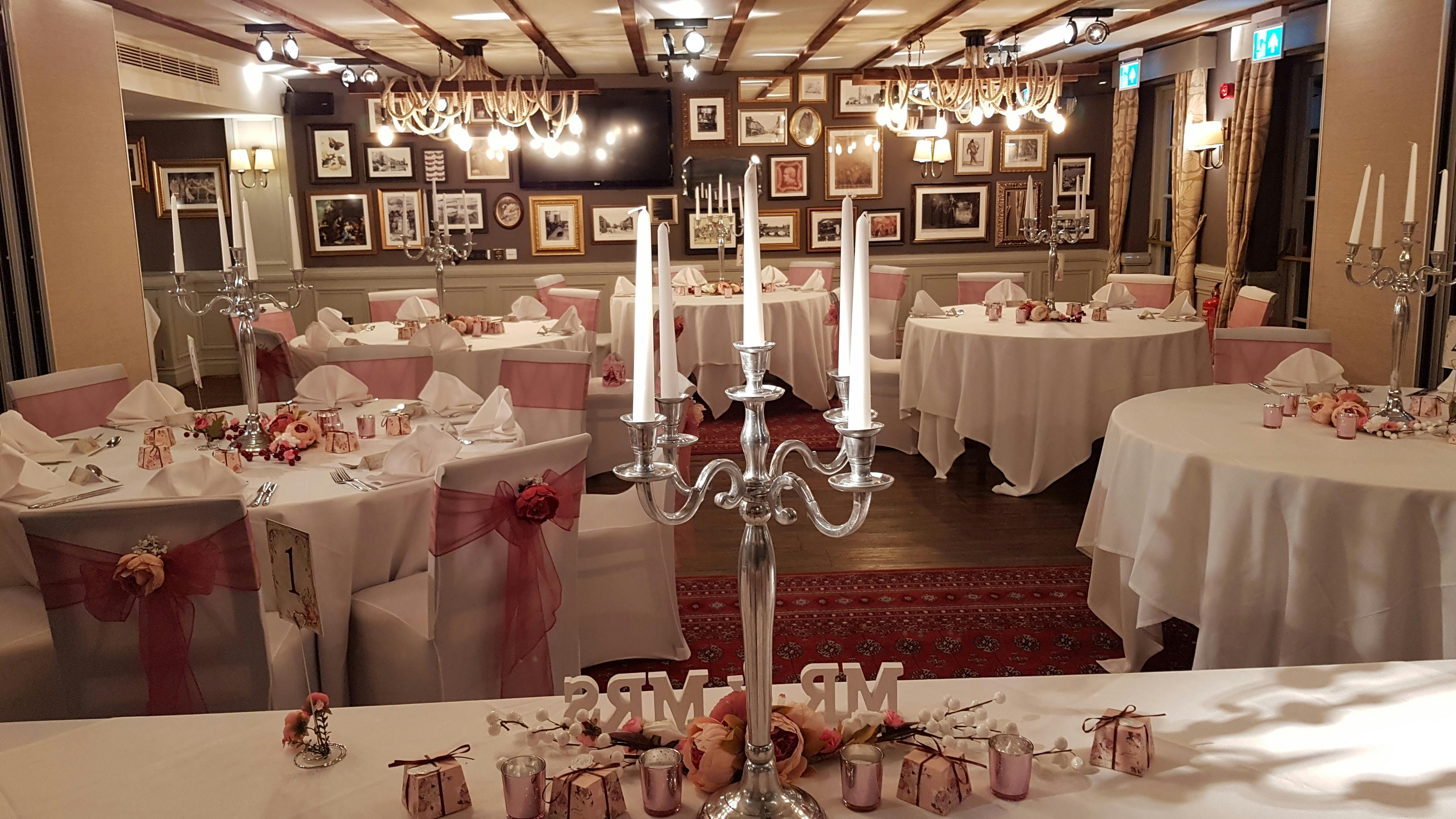 Elegant wedding venue at White Swan Hotel with romantic pink accents and candle centerpieces.