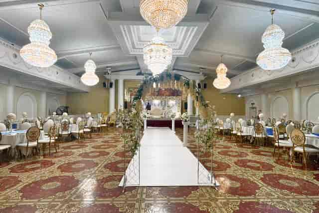 Wedding reception at Praba Banqueting Suite with floral arch, banquet seating, and luxury decor.