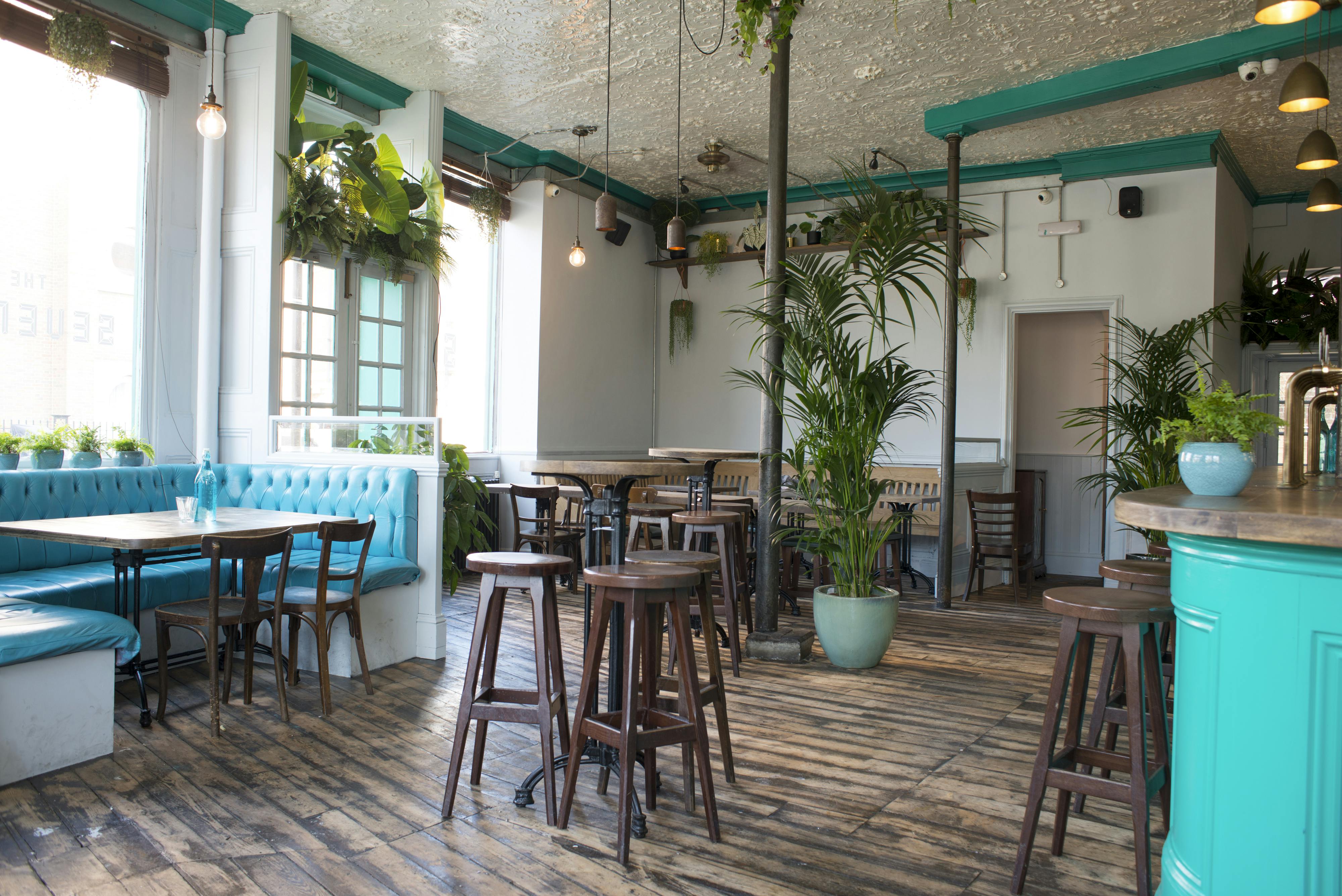 Main bar and Veranda at THE SEVENEY, vibrant decor for networking events and workshops.