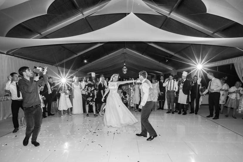 Wedding reception at South Lawns, The Queen's House, with couple dancing and vibrant ambiance.