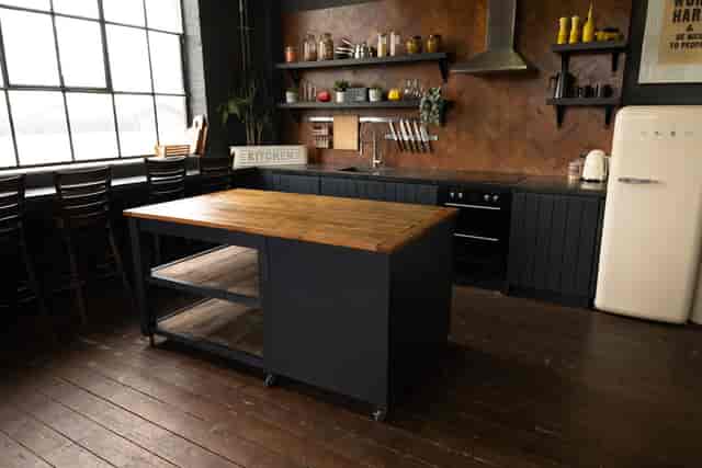Stylish kitchen with rustic island for cooking classes and culinary events at Crixus Studios.