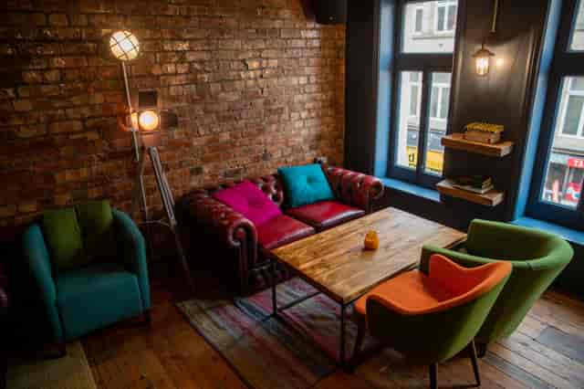 Cozy meeting space with vintage decor and exposed brick at 33 Oldham Street.