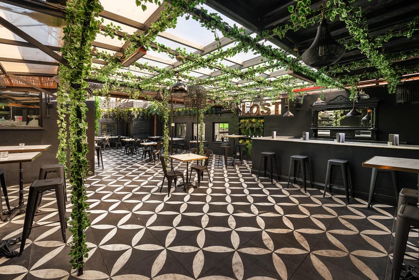 Stylish event space in Lost Garden with lush greenery, perfect for gatherings and parties.
