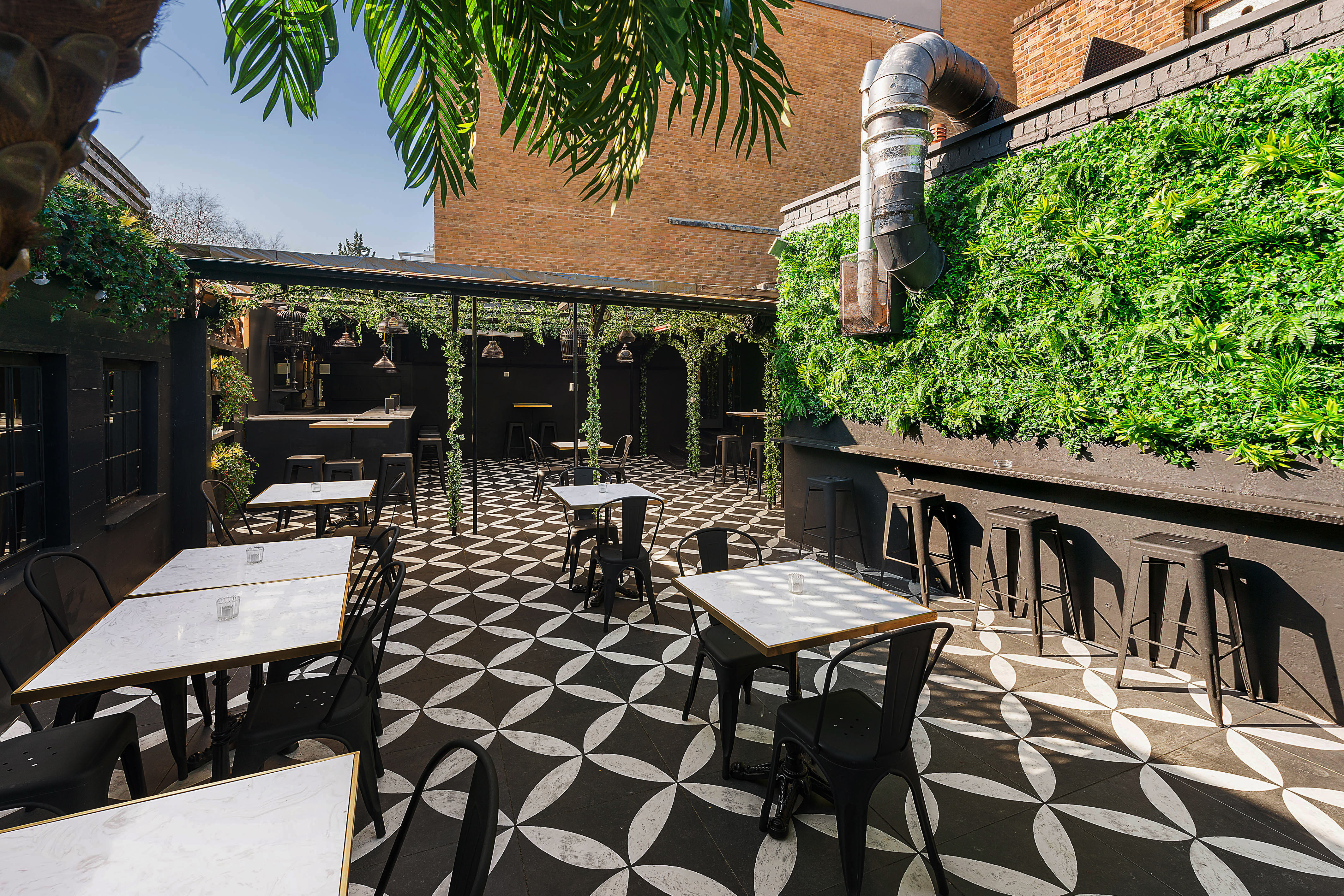 Stylish outdoor venue with lush greenery, perfect for networking events and receptions.