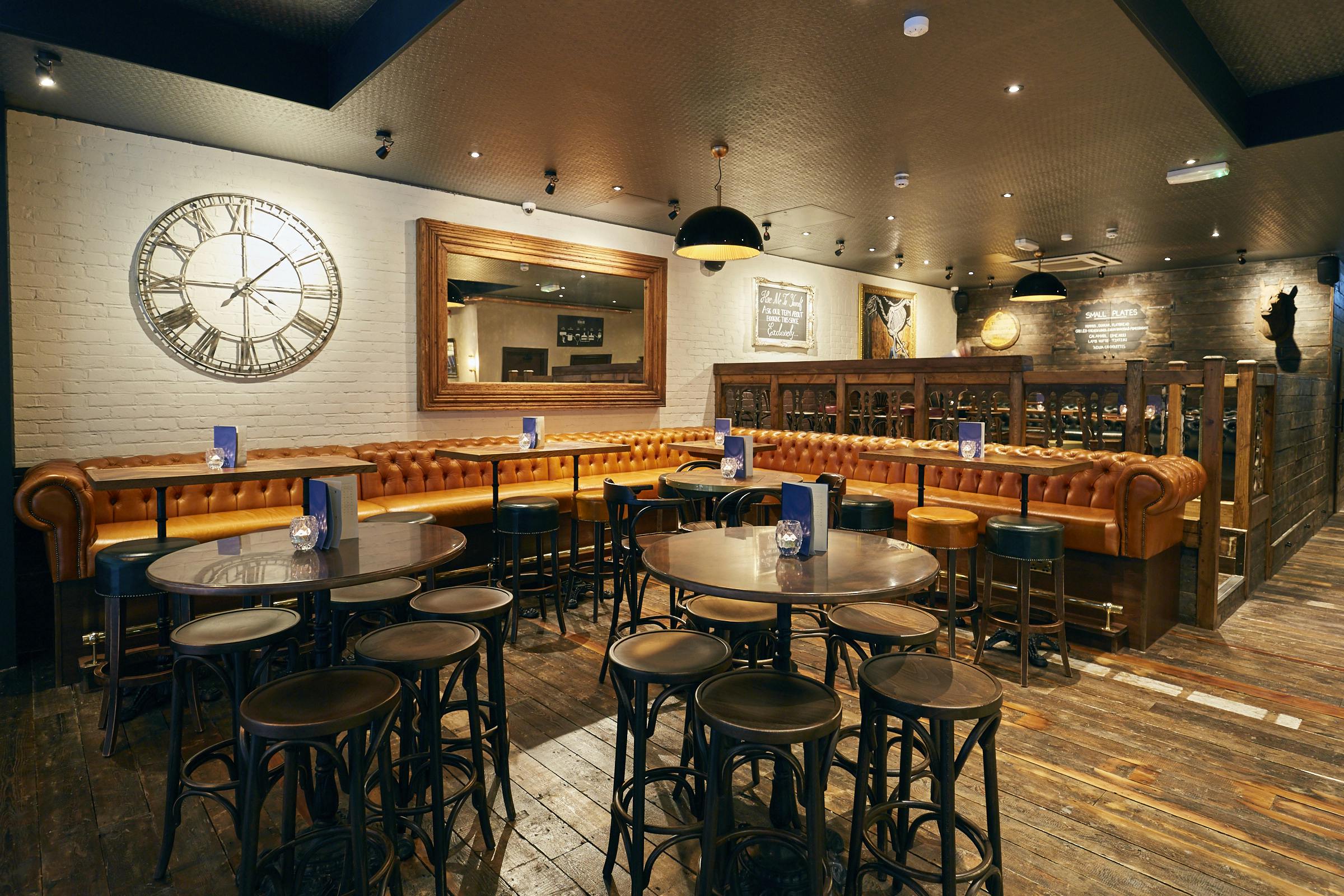 Stylish bar area with leather seating, perfect for networking events and casual meetings.