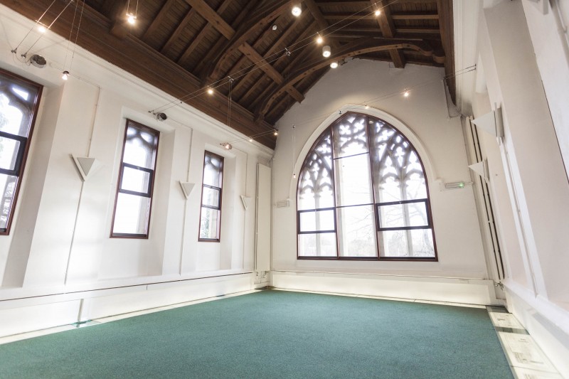 Spacious Trestle Theatre venue with wooden beams, ideal for events and workshops.