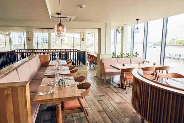 Stylish restaurant with water view, ideal for networking events and private dinners.