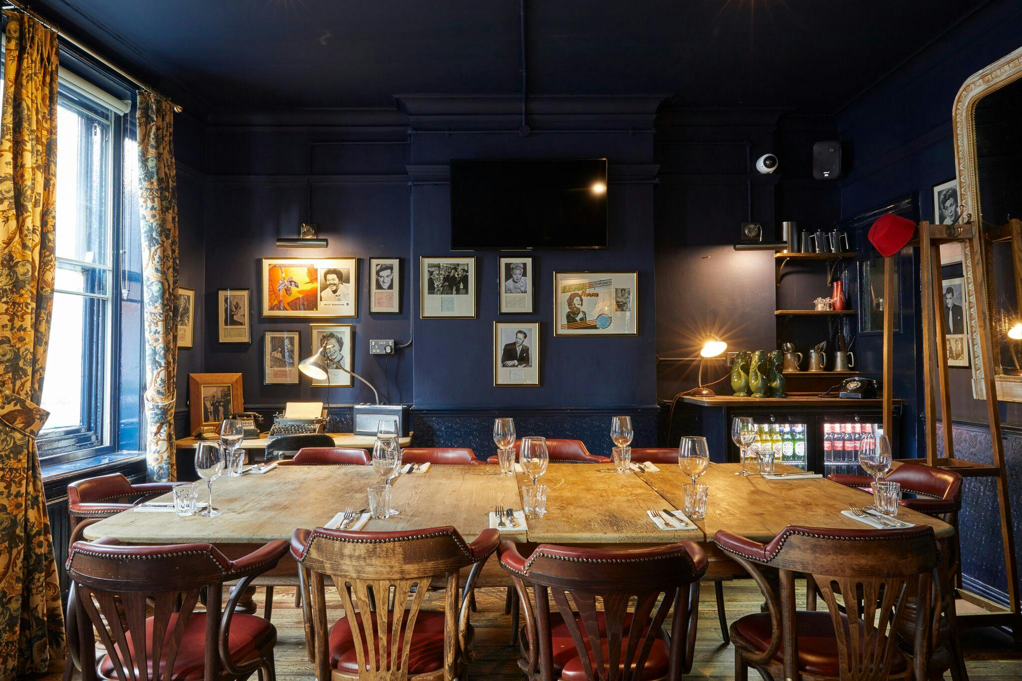 Stylish meeting room with wooden table in Bow Street Tavern, ideal for private dinners and gatherings.