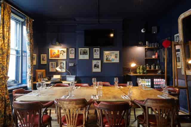 Intimate meeting space with wooden table at Bow Street Tavern for corporate events.