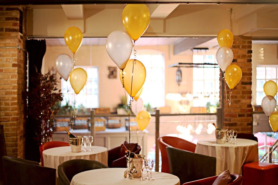 Charming event space with yellow balloons, perfect for celebrations and gatherings.