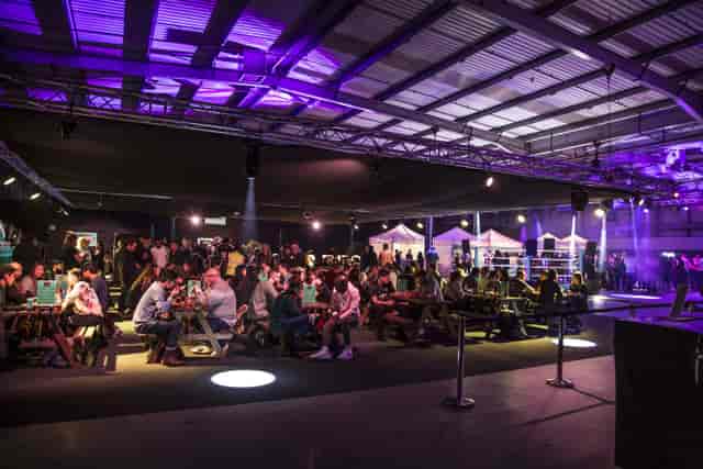 Vibrant Dock X London event space with picnic tables for networking and festivals.