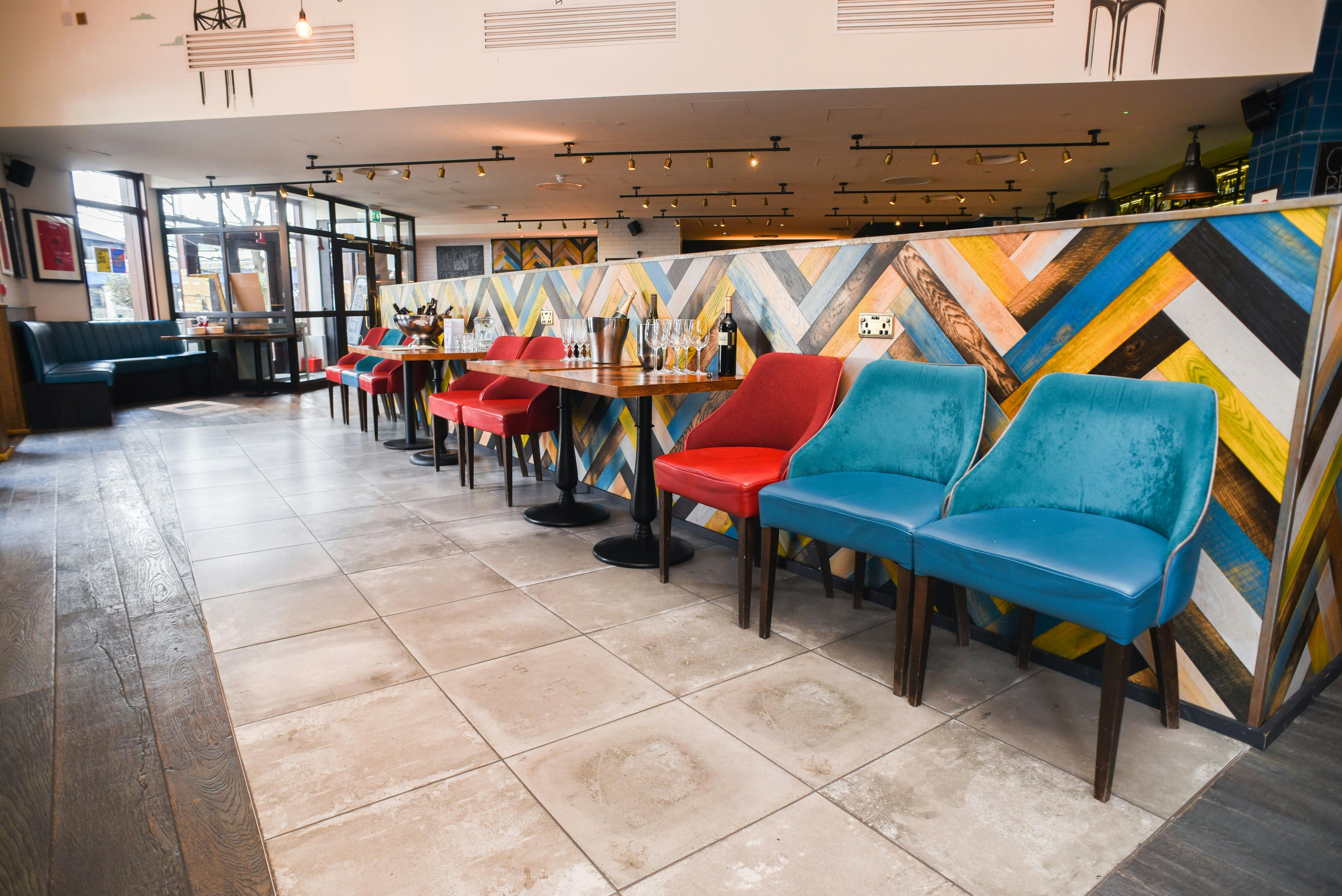 Vibrant event space with colorful chairs for casual meetings and networking.