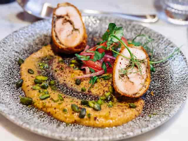Vibrantly plated gourmet dish at The Boulevard restaurant for event catering.