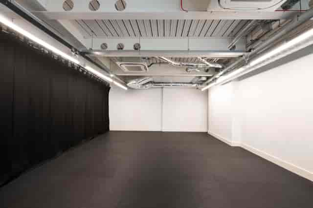 Flexible rehearsal room with minimalist design, perfect for workshops and events.