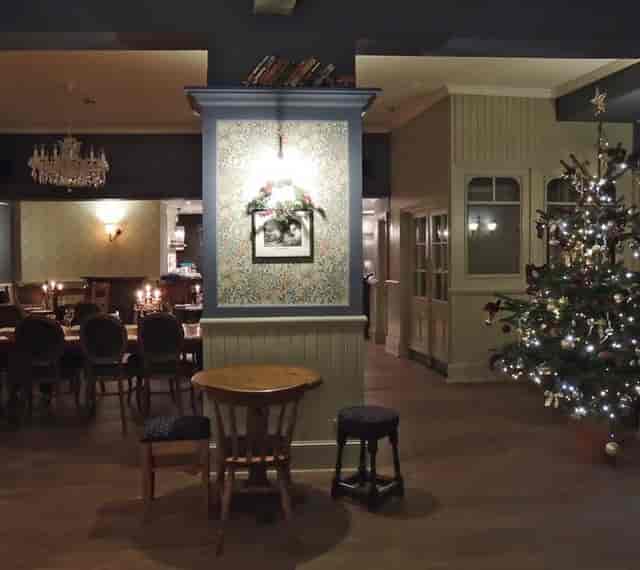 Cozy event space with Christmas tree, ideal for holiday parties at William Morris Bar.