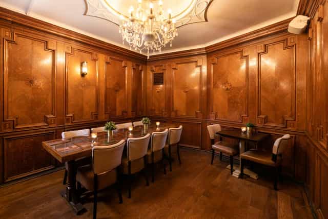 Elegant Boardroom at Pitcher & Piano Cornhill with wooden paneling for exclusive meetings.