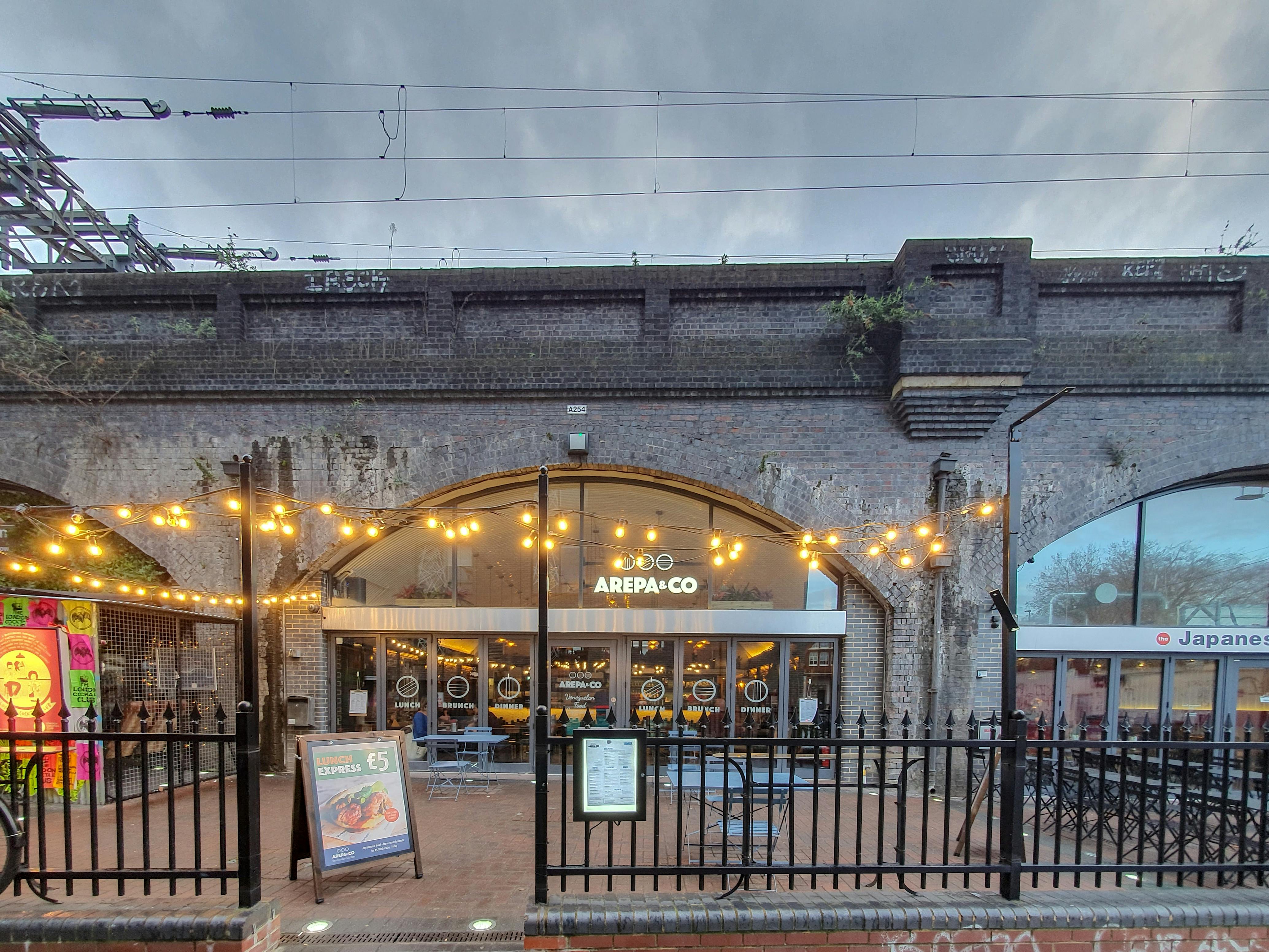 Private Mezzanine at Arepa & Co, vibrant venue with string lights for casual events.