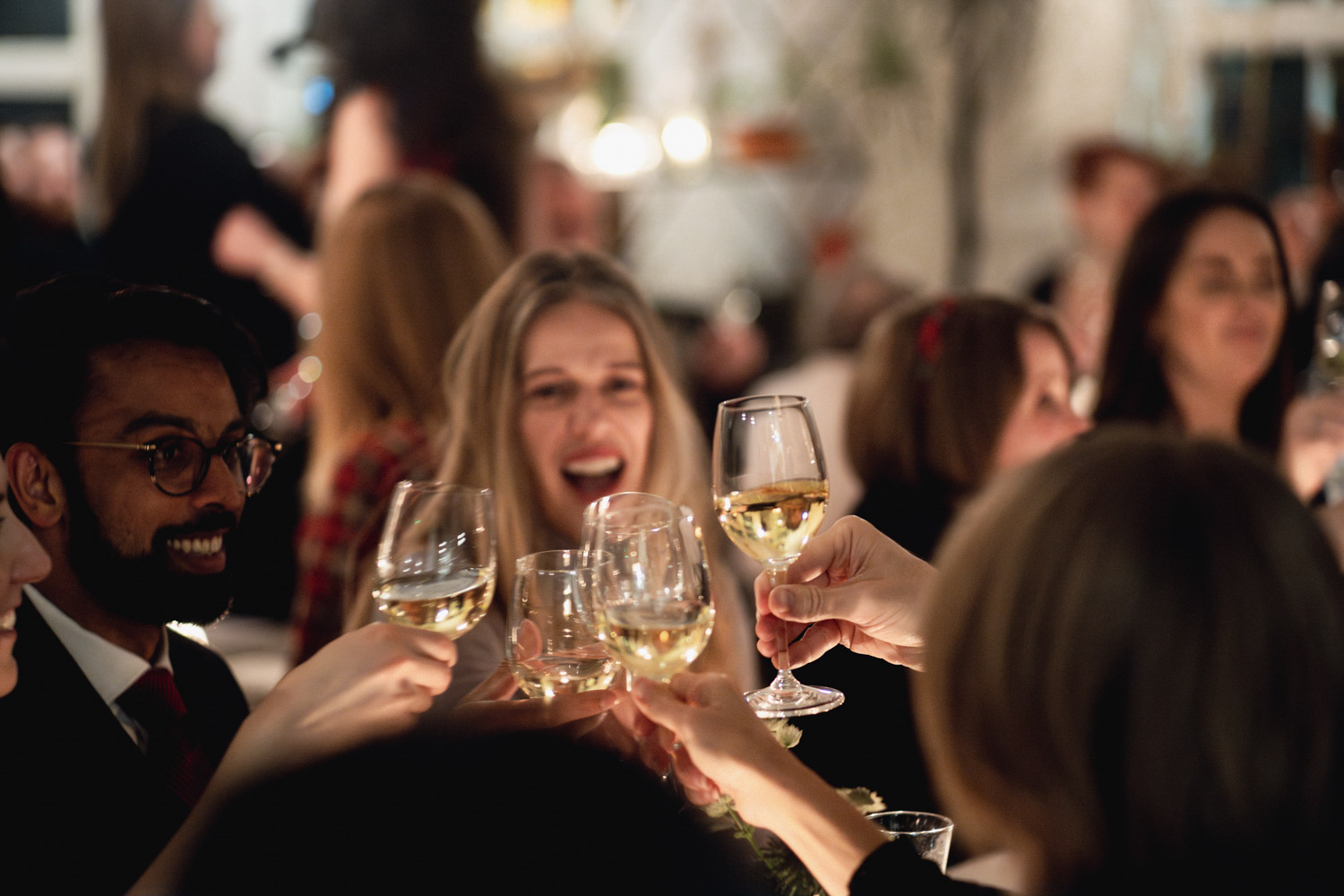 Gala networking reception in a festive townhouse with guests toasting at a successful event. - Banner
