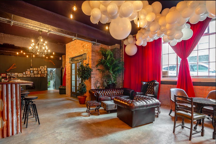 Stylish U7 Lounge venue with plush seating and whimsical balloon decor for events.