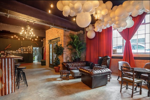 Stylish U7 Lounge venue with plush seating and whimsical balloon decor for events.