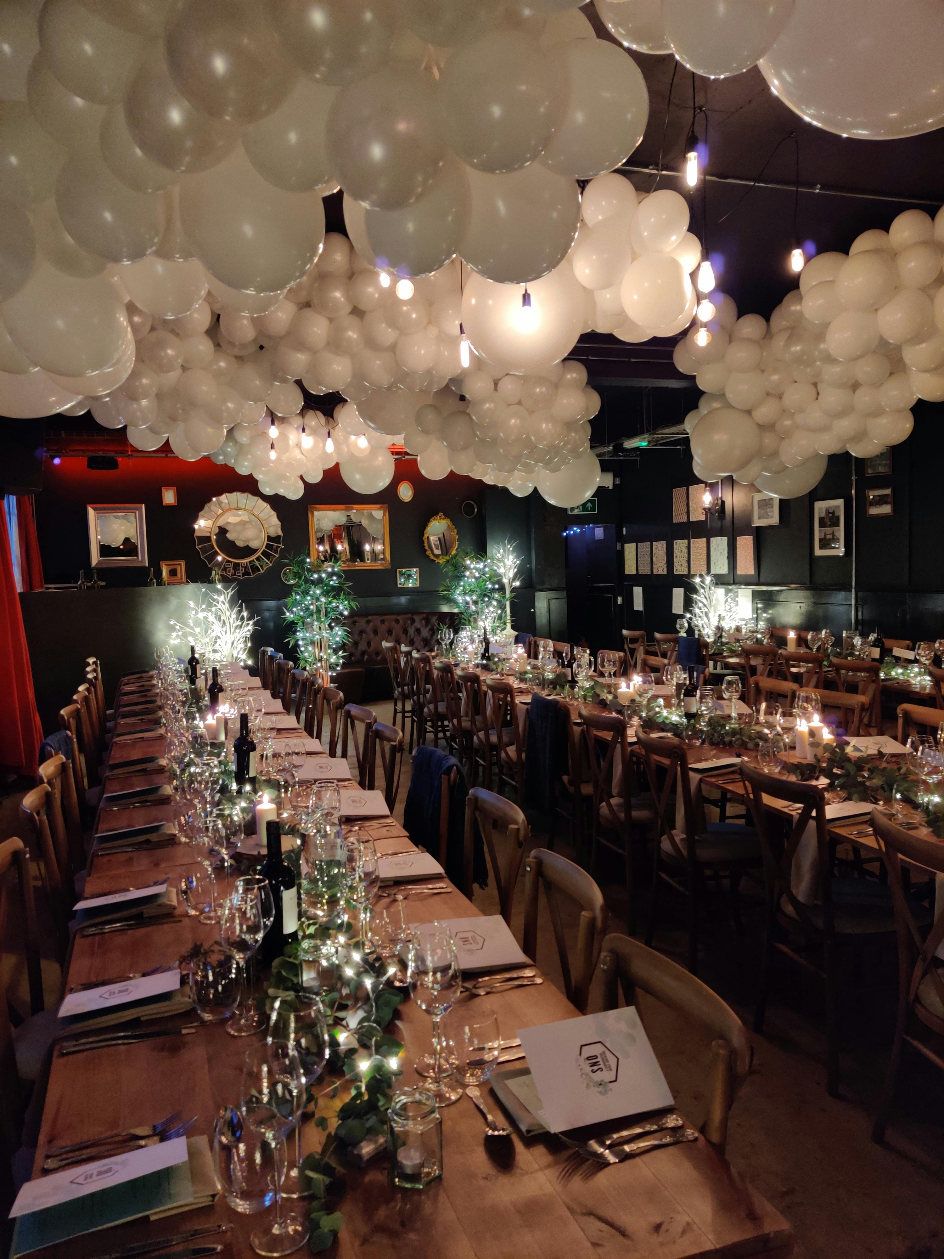 Elegant long table setup in U7 Lounge for upscale dinner events with soft lighting.