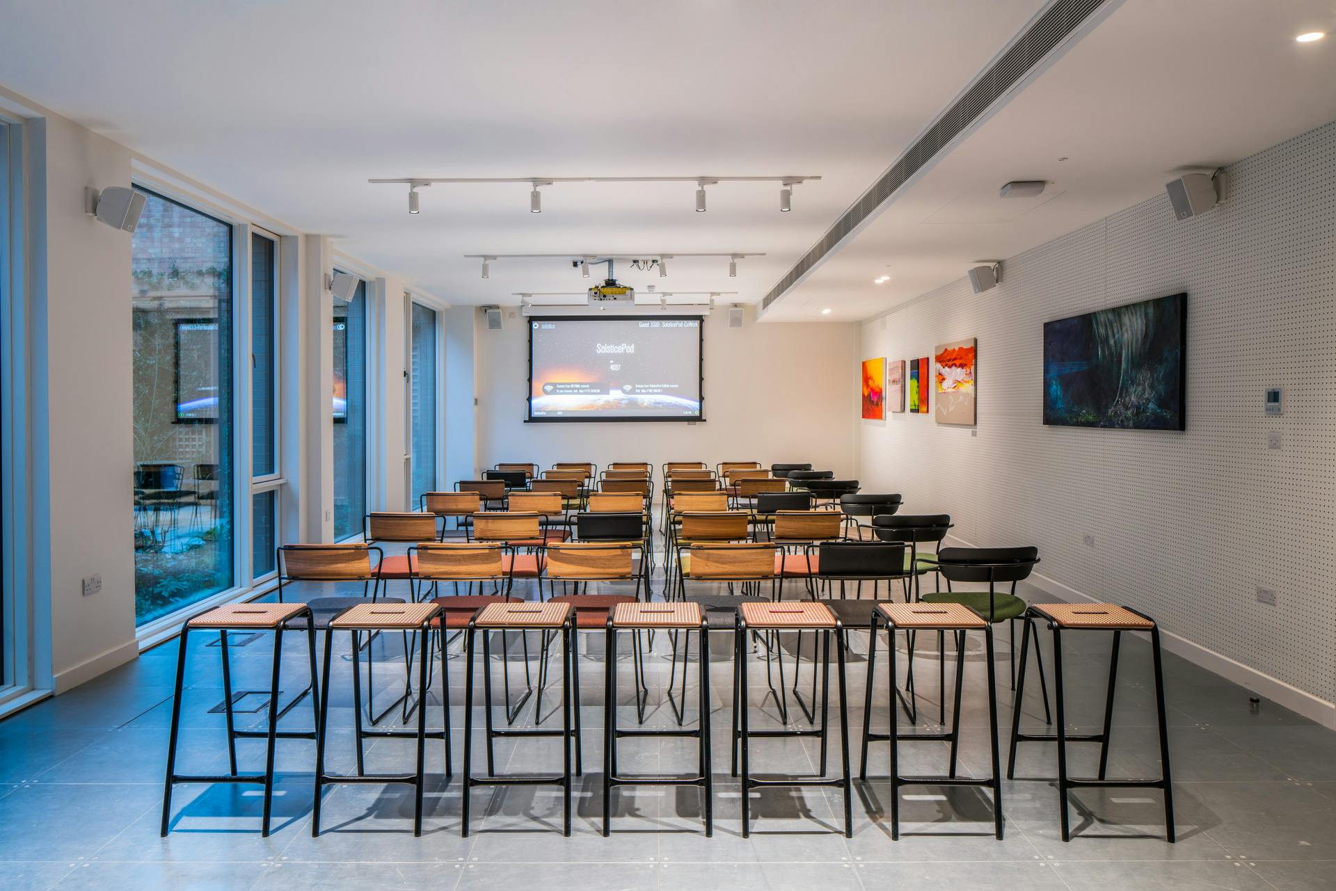 Modern event space with high-top chairs for workshops in People's Mission Hall.