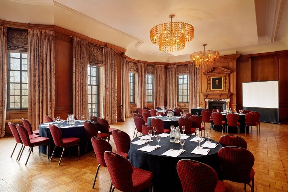 Elegant Grand Boardroom with wood paneling, ideal for corporate meetings and events.