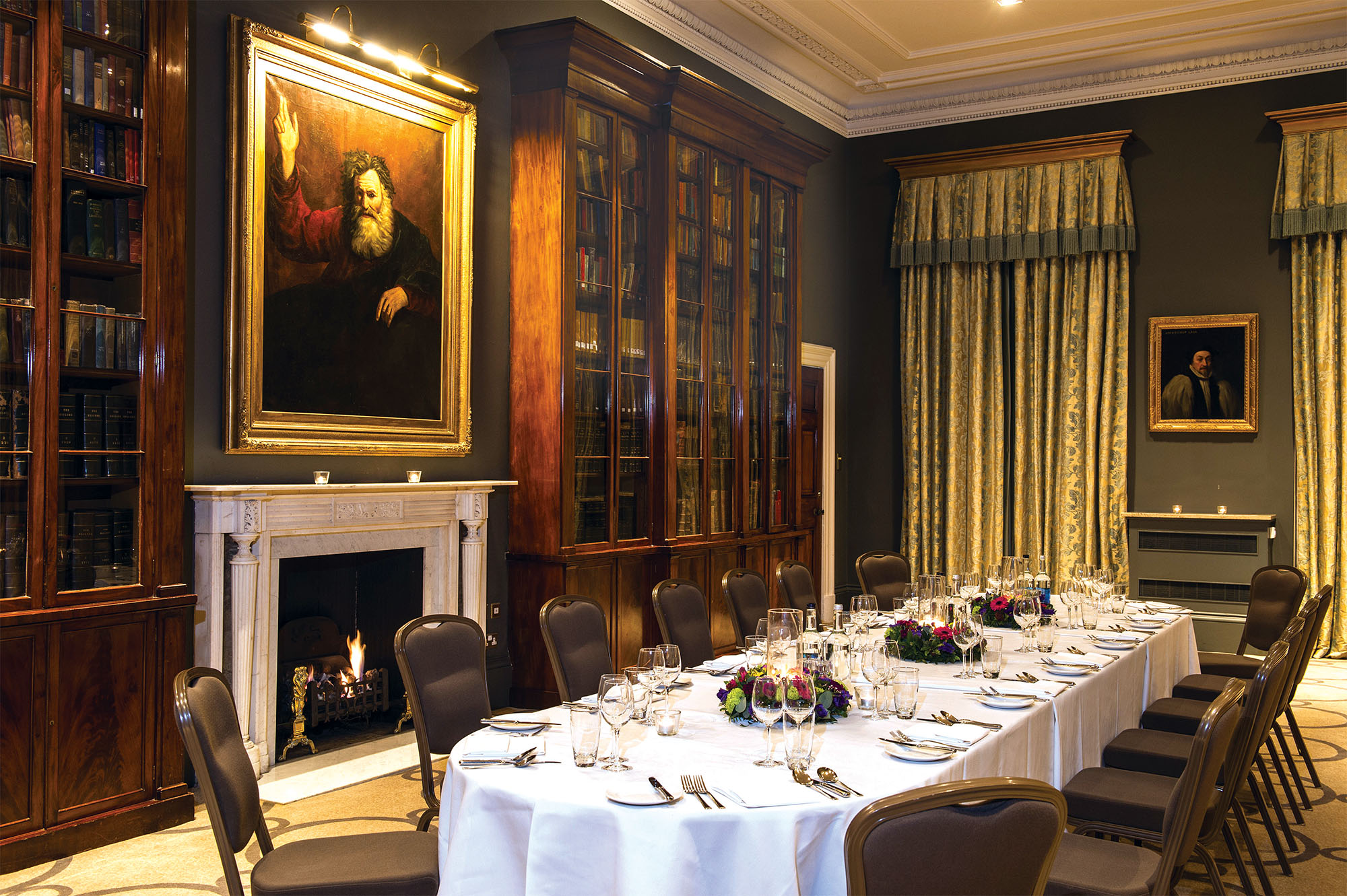 Elegant dining room in Rudding Park, set for formal events with fine tableware and floral decor.
