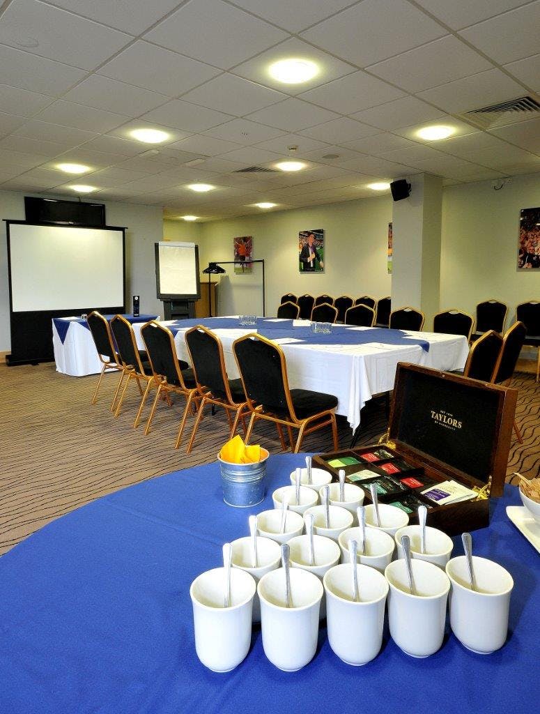 The Needler Suite in MKM Stadium, featuring a large meeting table for professional events.