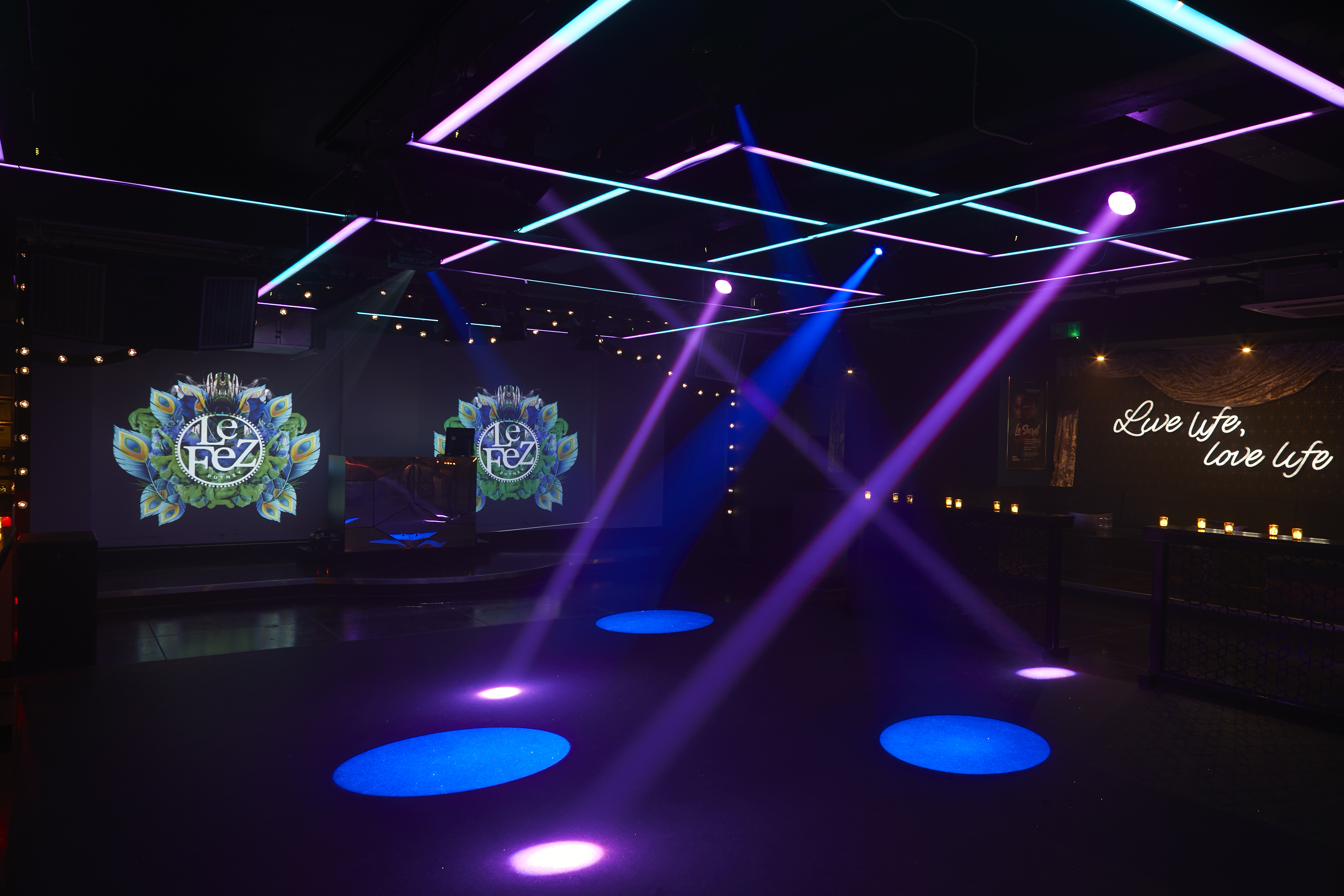 Vibrant event space in Le Fez with colorful lighting for parties and corporate events. - Banner