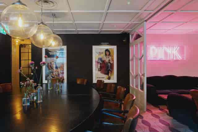 Stylish meeting space at The River Bar with round table, ideal for collaborative events.