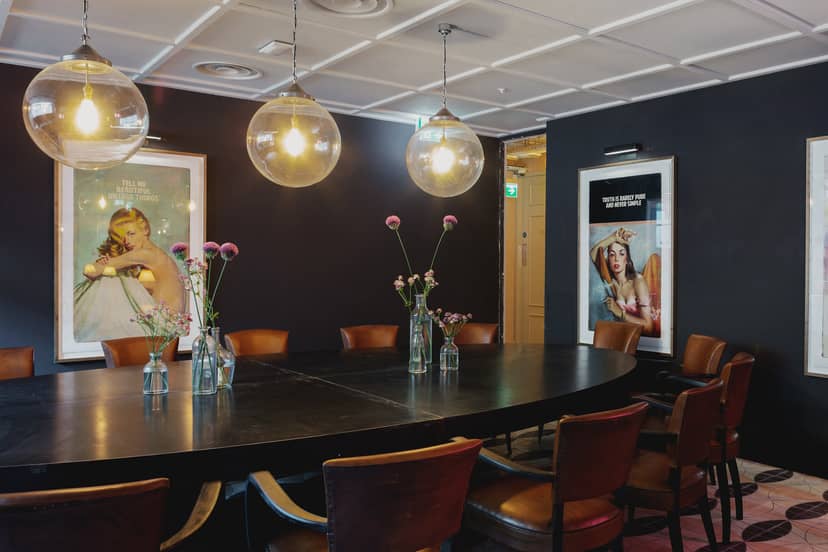 Stylish meeting room with round table at The River Bar, ideal for events and collaboration.
