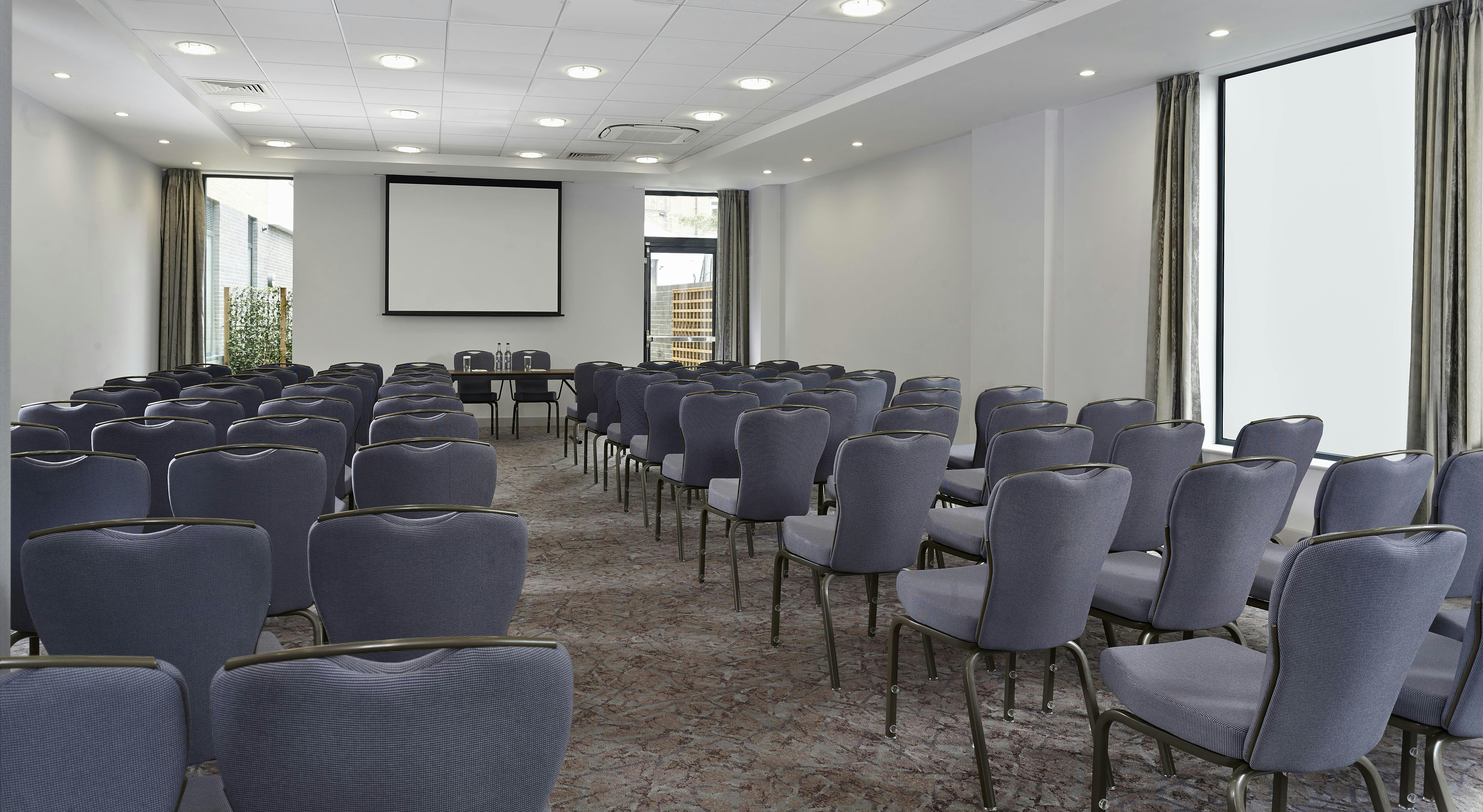 Claremont Suite meeting room with grey chairs, ideal for conferences and workshops.