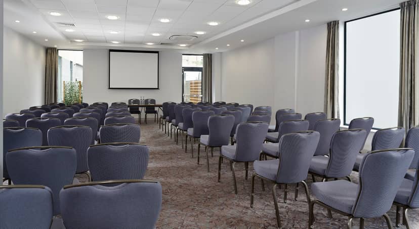 Claremont Suite meeting room with grey chairs, ideal for conferences and workshops.