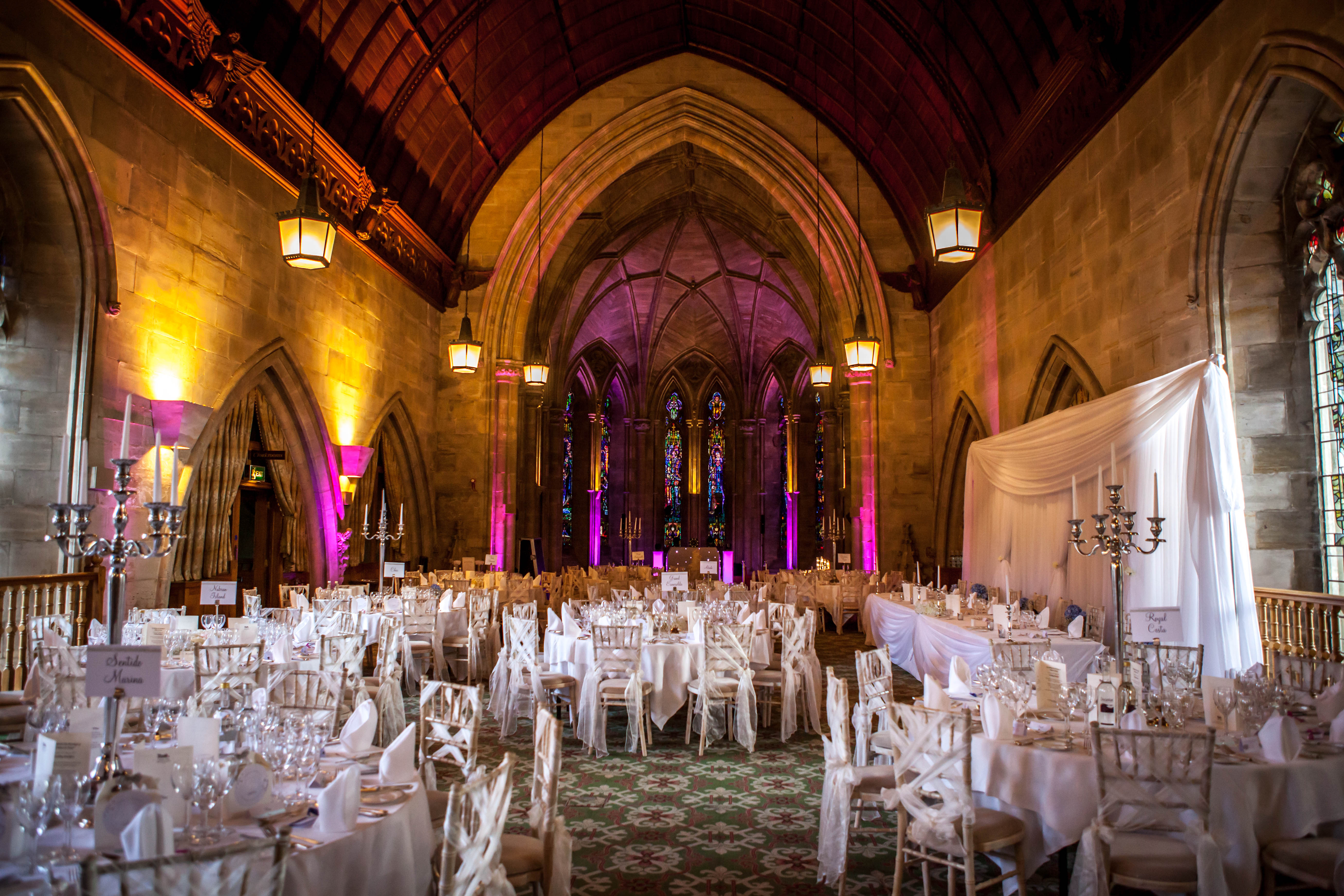 Elegant banquet hall with round tables, ideal for weddings and gala dinners. - Banner