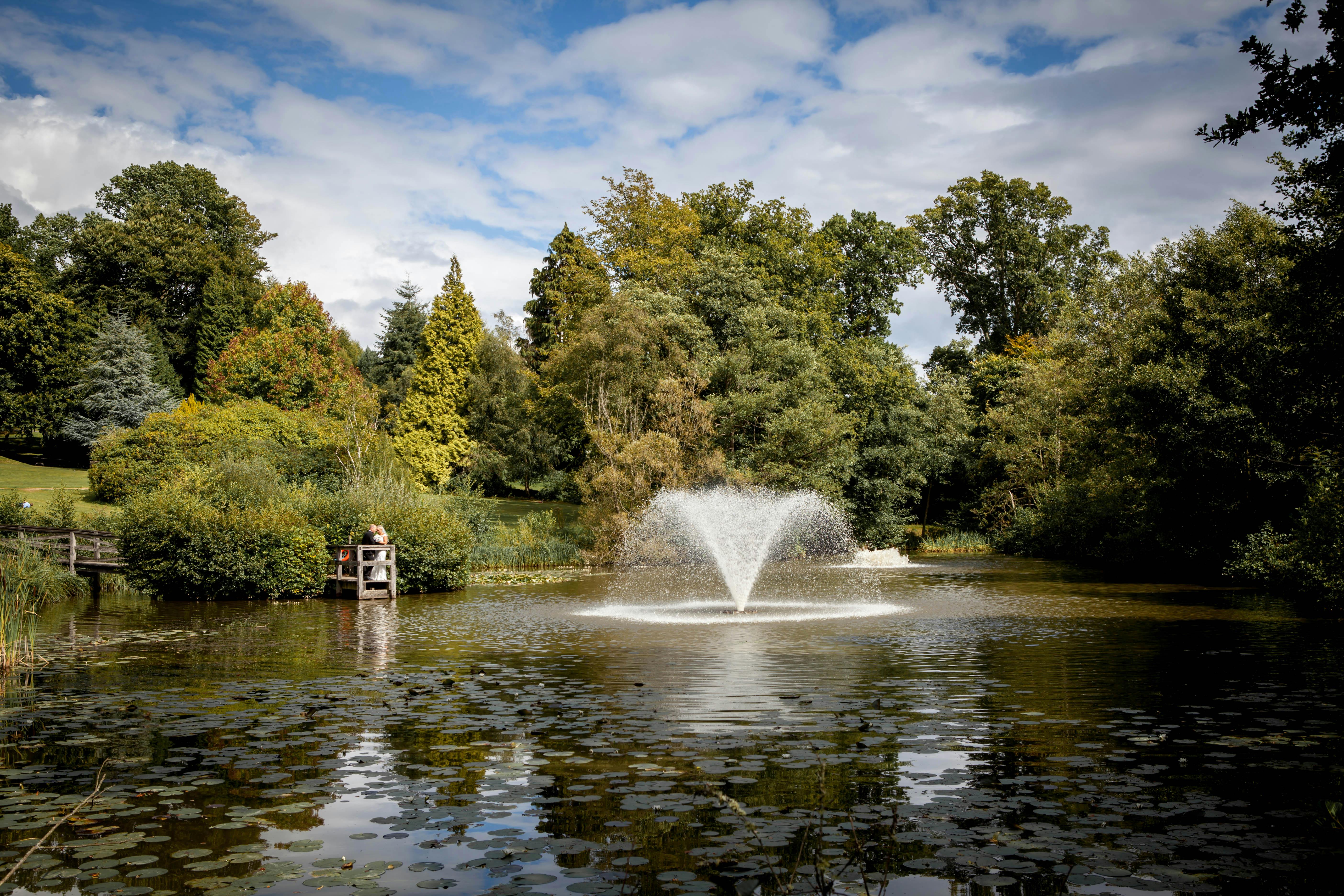 Harry Clarke by tranquil pond at Ashdown Park Hotel, perfect for outdoor events and retreats.