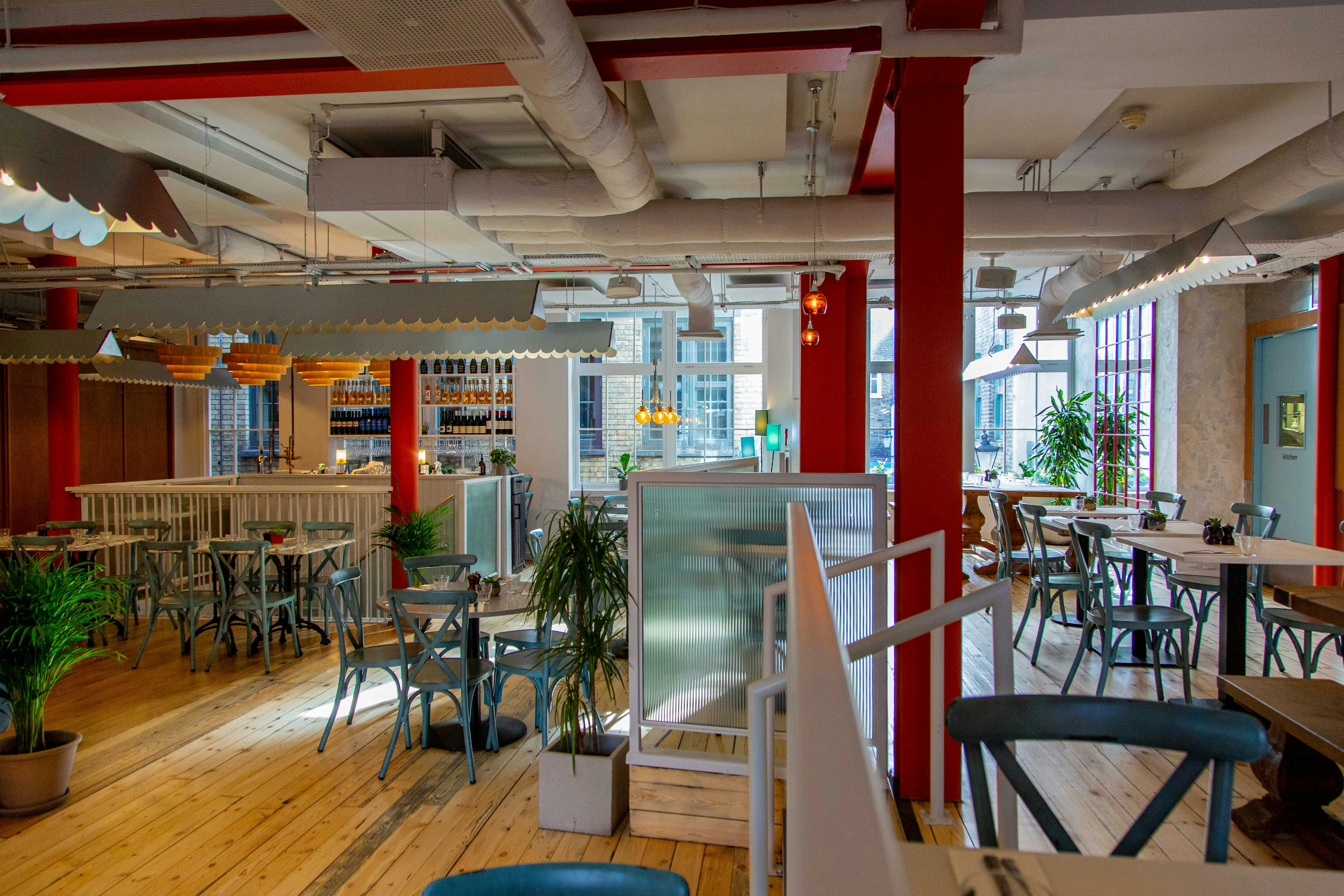 Modern open-concept event space with natural light, ideal for meetings and gatherings.
