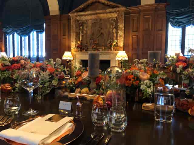 Elegant dining table with floral arrangements in L'oscar London for corporate events.