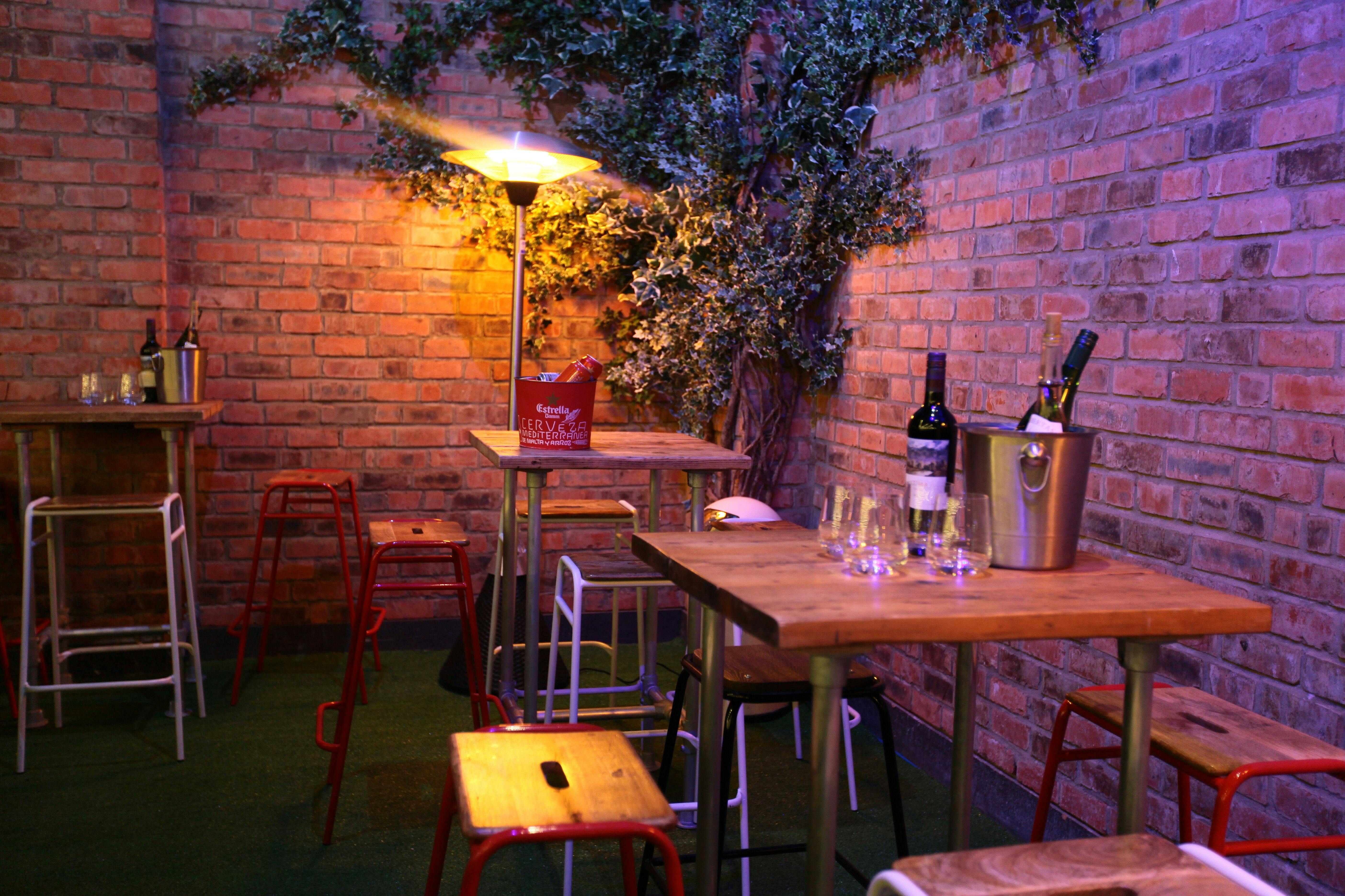 Cozy event space with rustic brick walls for cocktail receptions and gatherings.