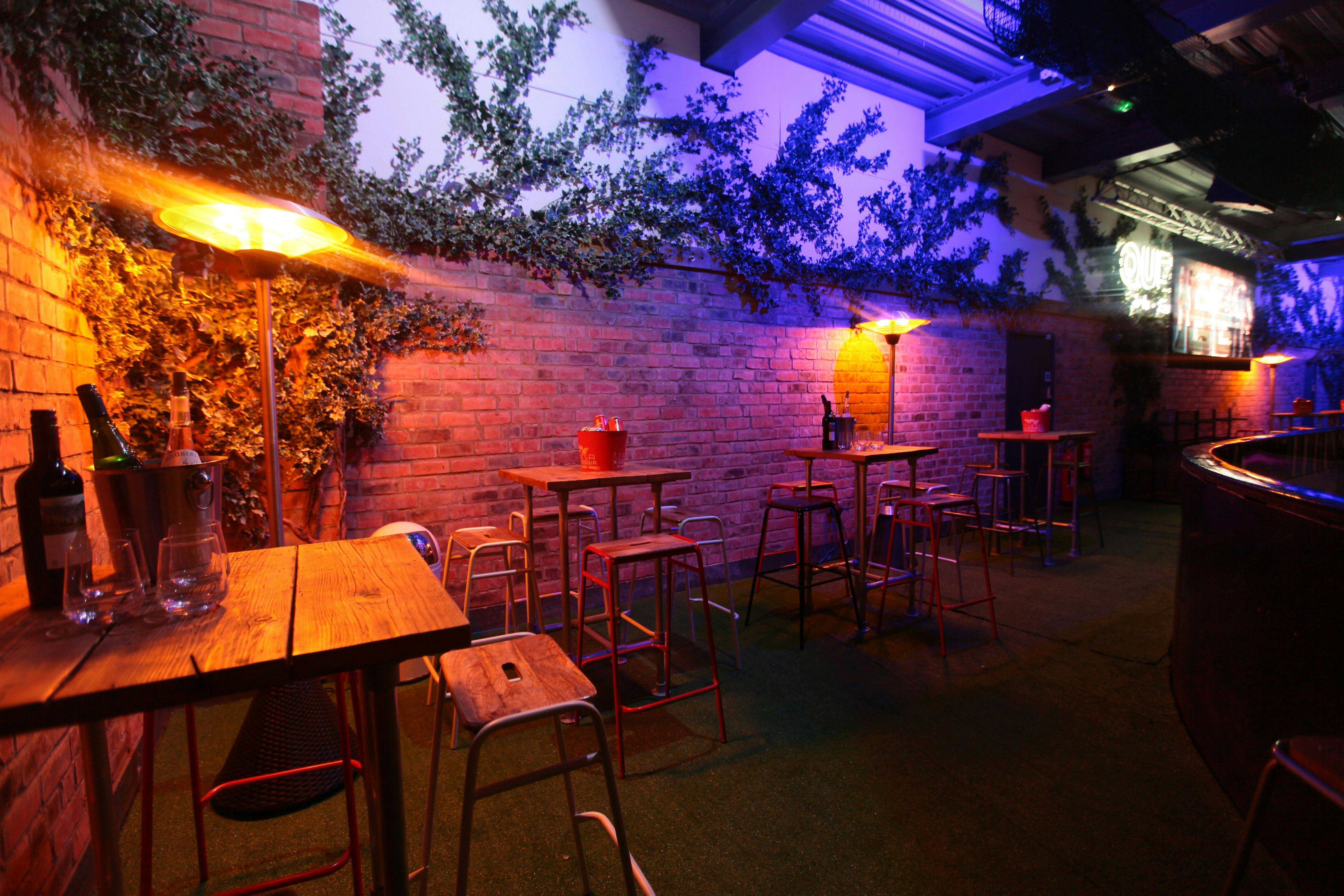 "Stylish event space with rustic tables at QUEENS Skate Dine Bowl for networking and receptions."