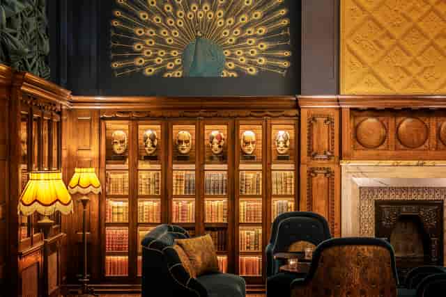 Elegant meeting space in L'oscar London with peacock mural, ideal for networking events.