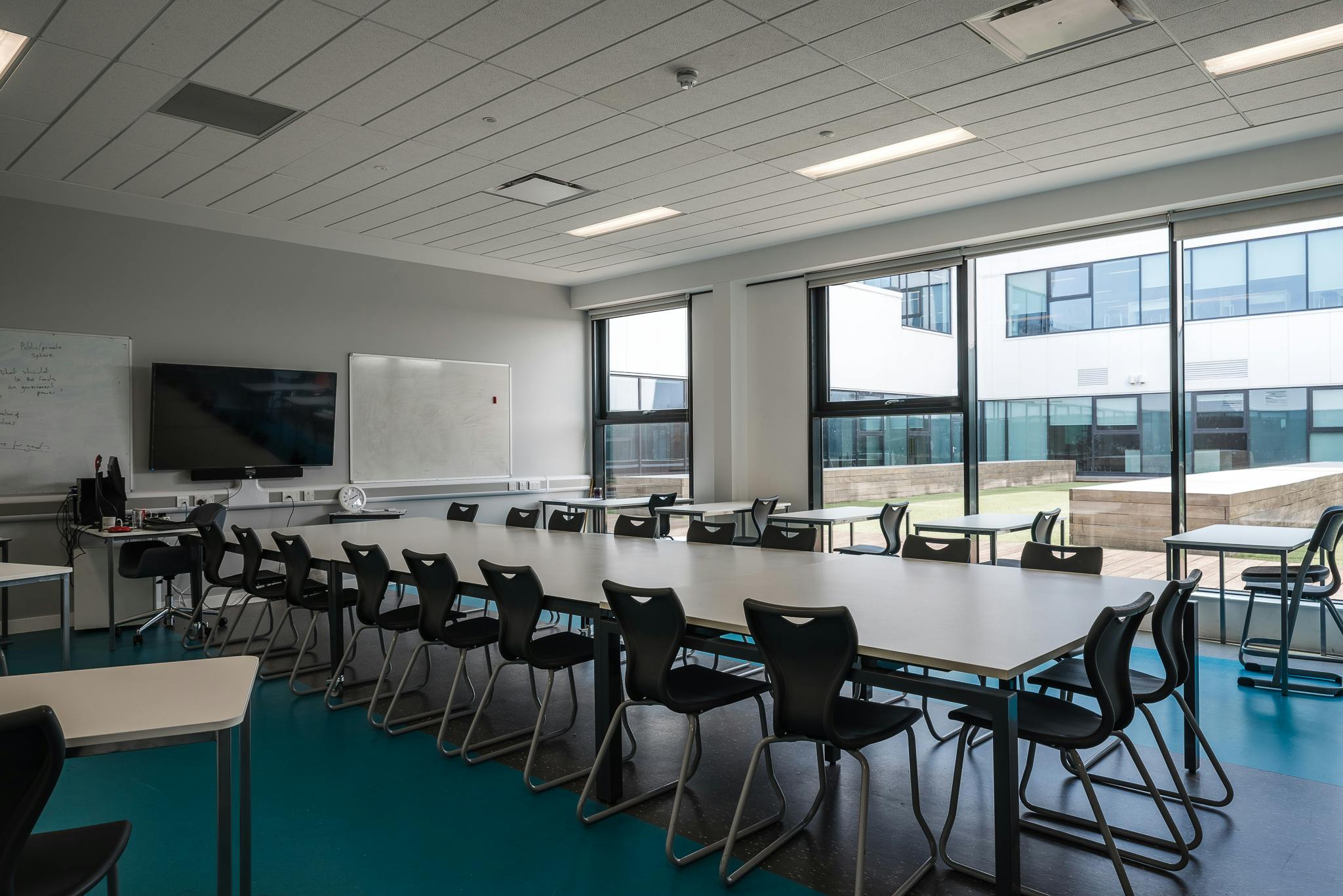 Modern breakout room with natural light for workshops and presentations in London Academy.