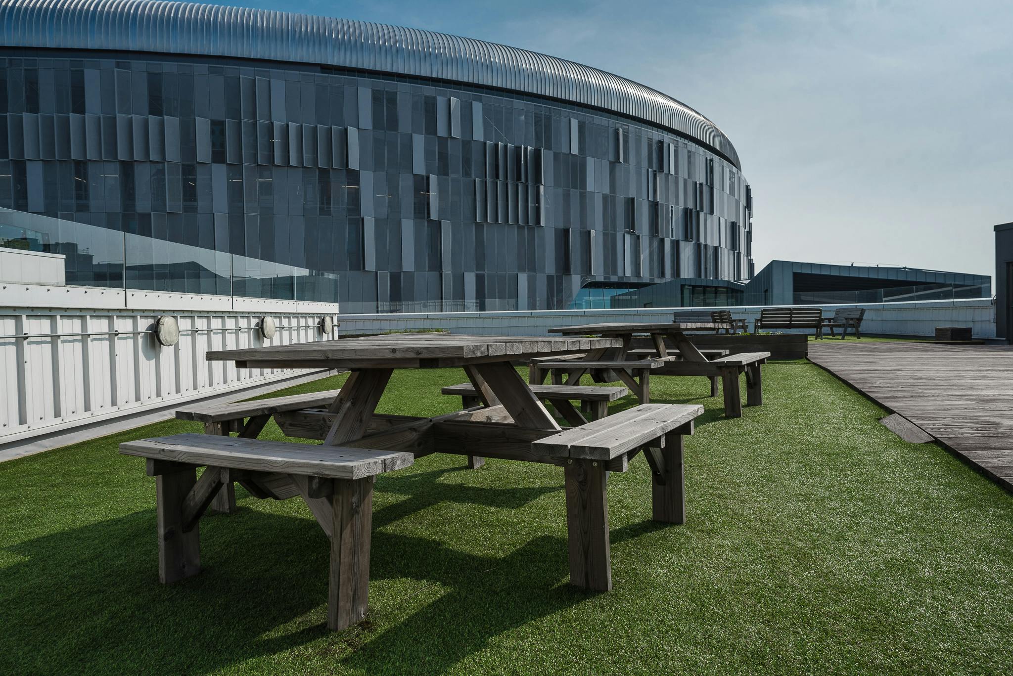Roof terrace at London Academy of Excellence Tottenham with picnic tables for outdoor events.