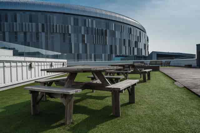 Roof terrace at London Academy of Excellence Tottenham with picnic tables for outdoor events.